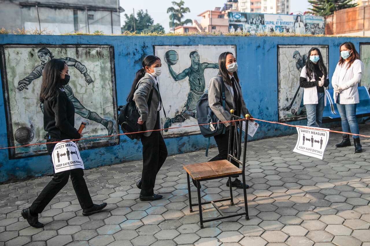 Students seen in a social distance line at Saipal Academy during the examinations.