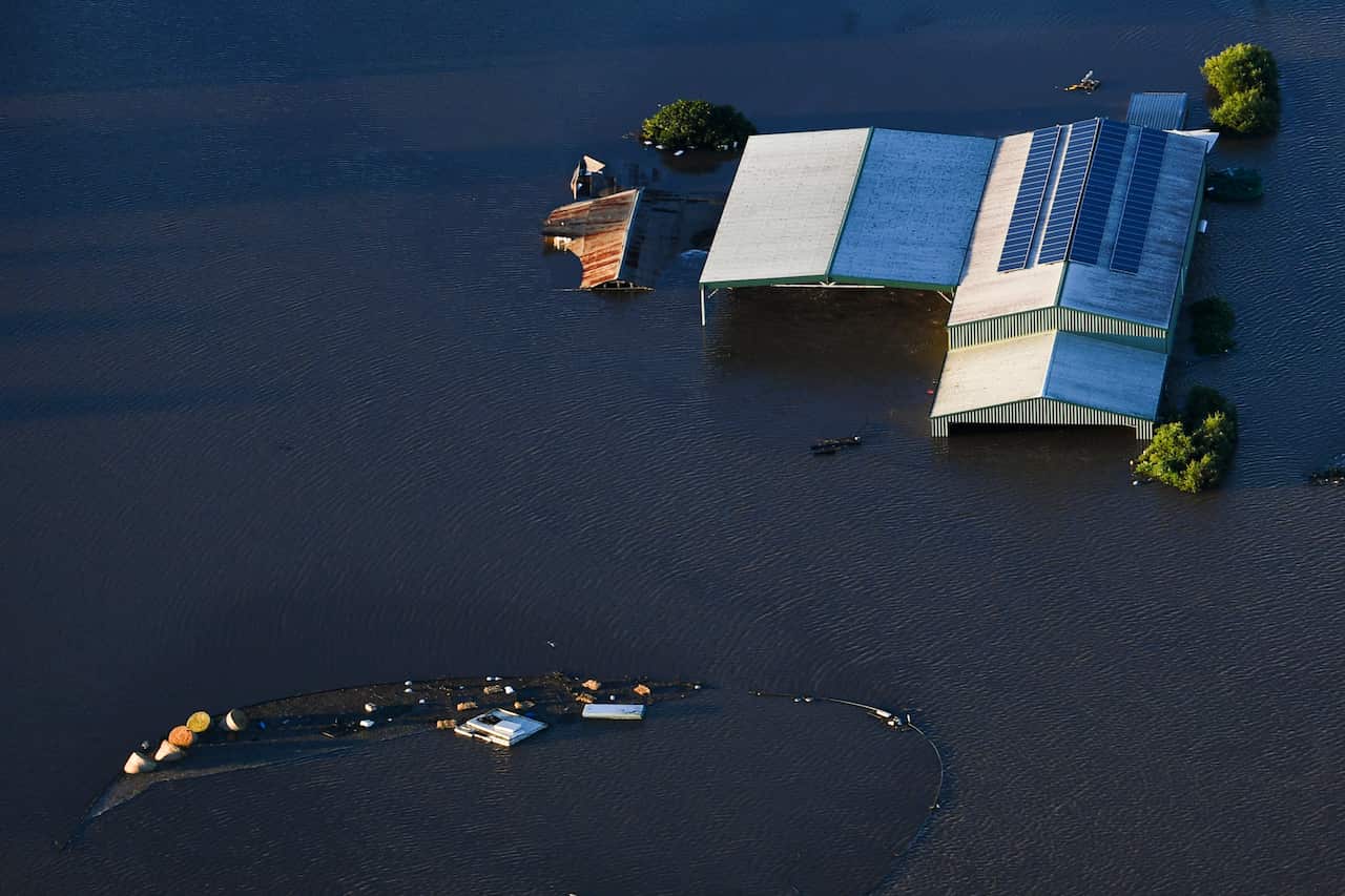 Submerged houses are seen from a helicopter in flood affected areas in the Windsor and Pitt Town areas along the Hawkesbury River near Sydney, Wednesday, March 24, 2021. (AAP Image/Lukas Coch) NO ARCHIVING