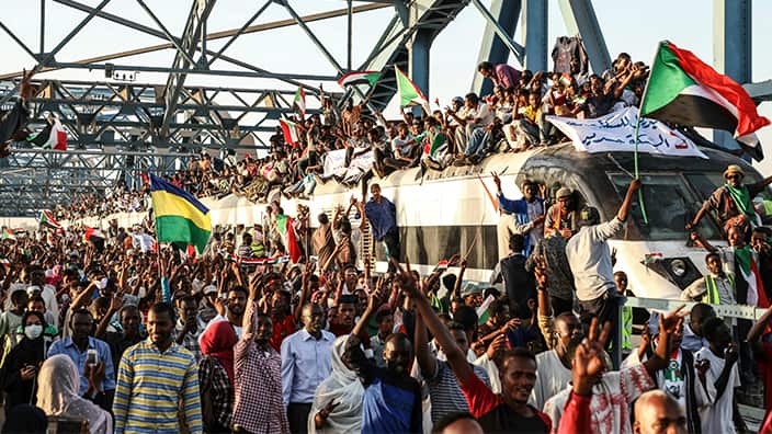 Sudanese protesters crowd a train in the capital Khartoum. 