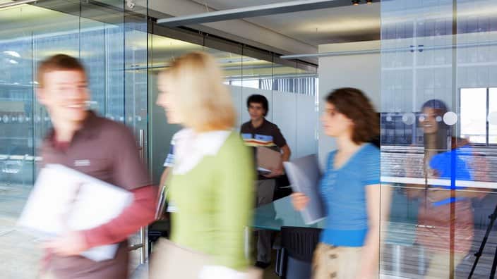 Office workers leaving conference room long exposure