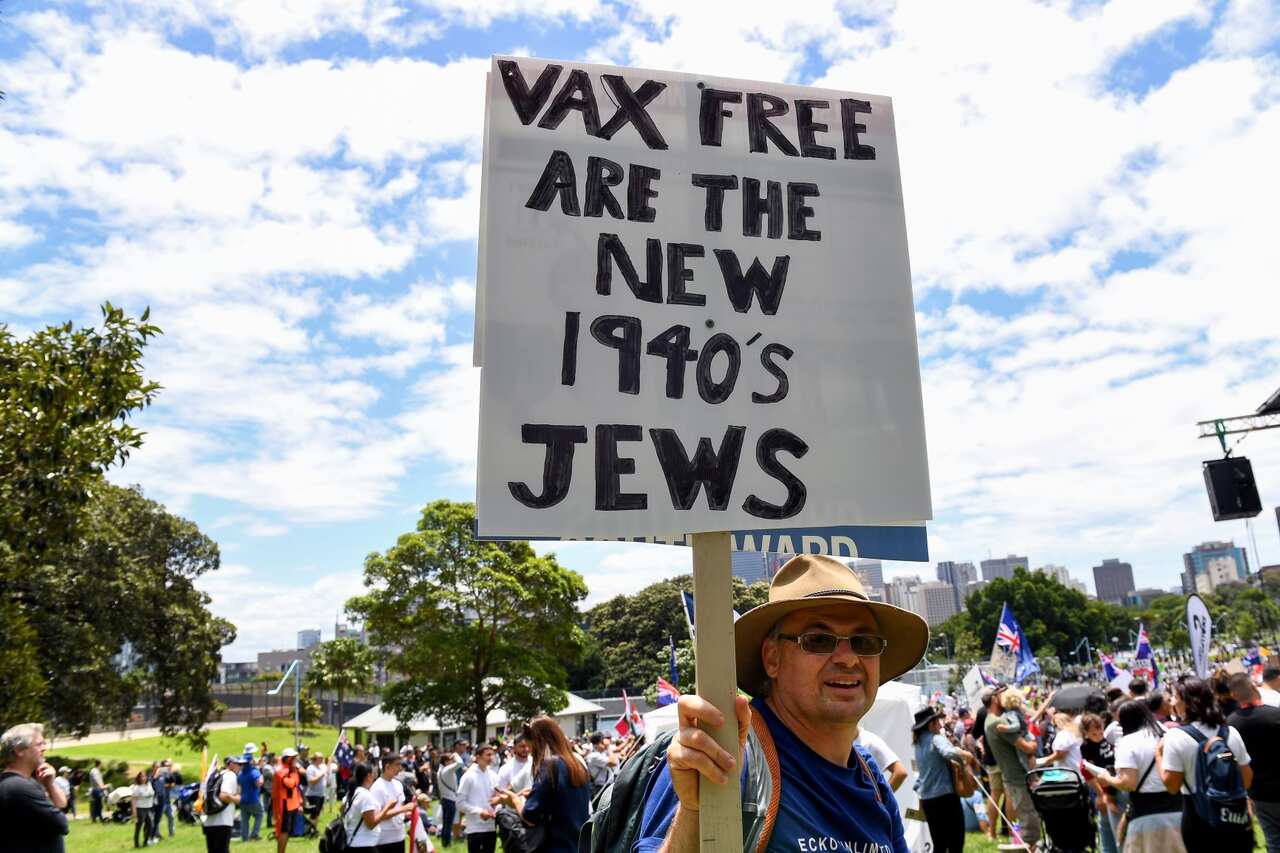Protesters hold placards during a #ReclaimTheLine rally dubbed 'Face the Music', against vaccine mandates and vaccine passports in Sydney