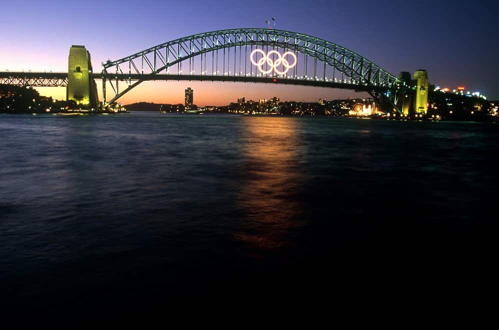 The Sydney Harbour Bridge and the Olympic rings at twilight, from the Opera House