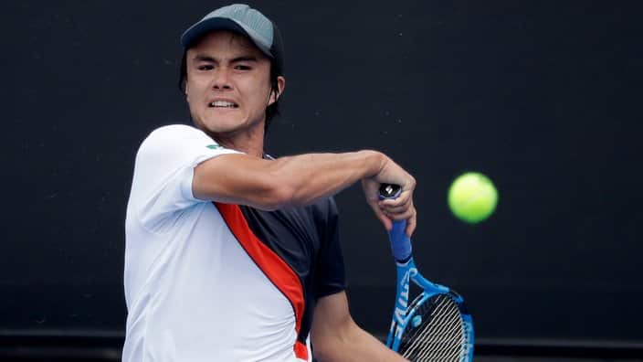 Japan's Taro Daniel hits a forehand return to Australia's Thanasi Kokkinakis during their first round match at the Australian Open tennis championships in Melbourne, Australia, Tuesday, Jan. 15, 2019. (AP Photo/Kin Cheung)