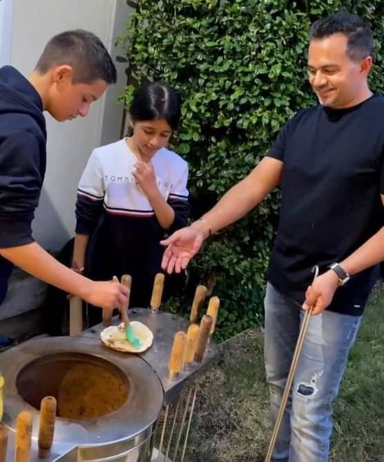 Tarun Gupta (right) with his family at their house in Sydney.