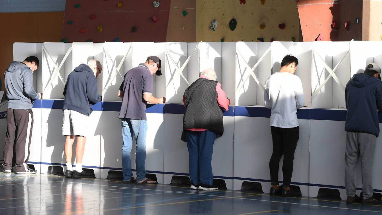 Voters complete their ballot forms 
