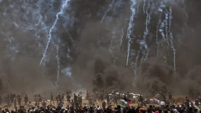 Israeli troops fire tear-gas at Palestinian protesters during clashes after protests near the border with Israel
