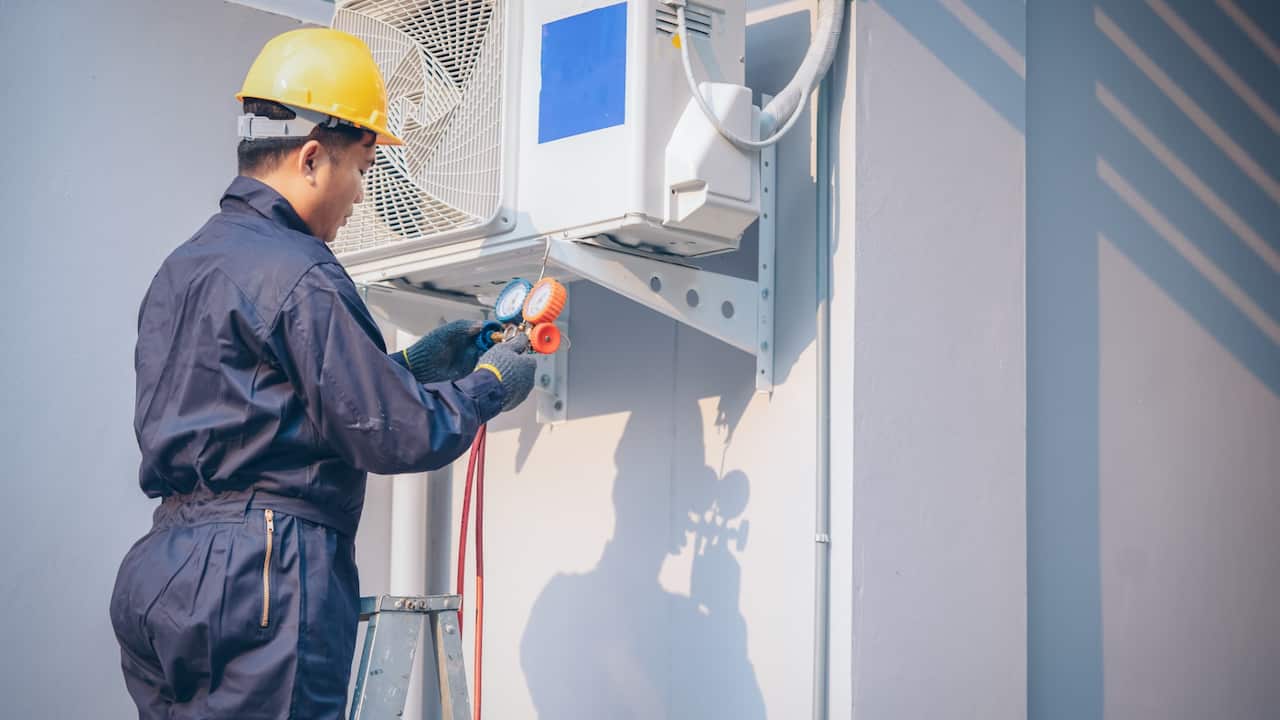 Technician repairing aircon