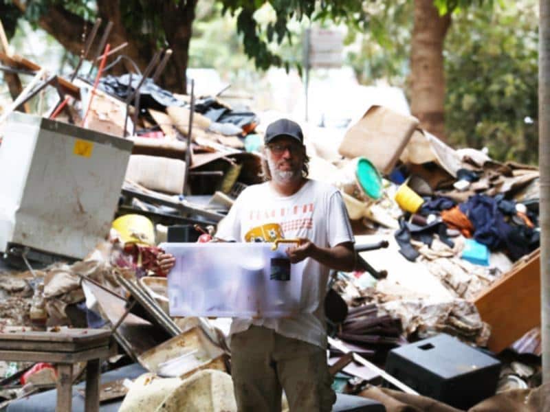 A man sorts through the wreckage left by the current floods in new South Wales.