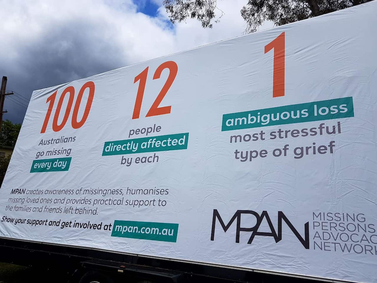 The other side of the billboard with Tej's photo, talking about community impact