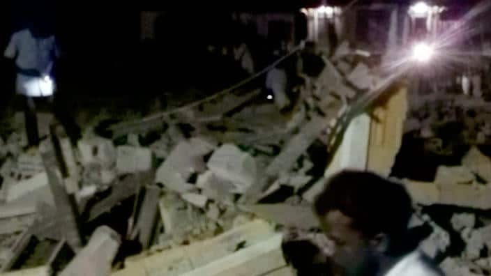 Rescuers going through the debris after the fire, to look for any more survivors