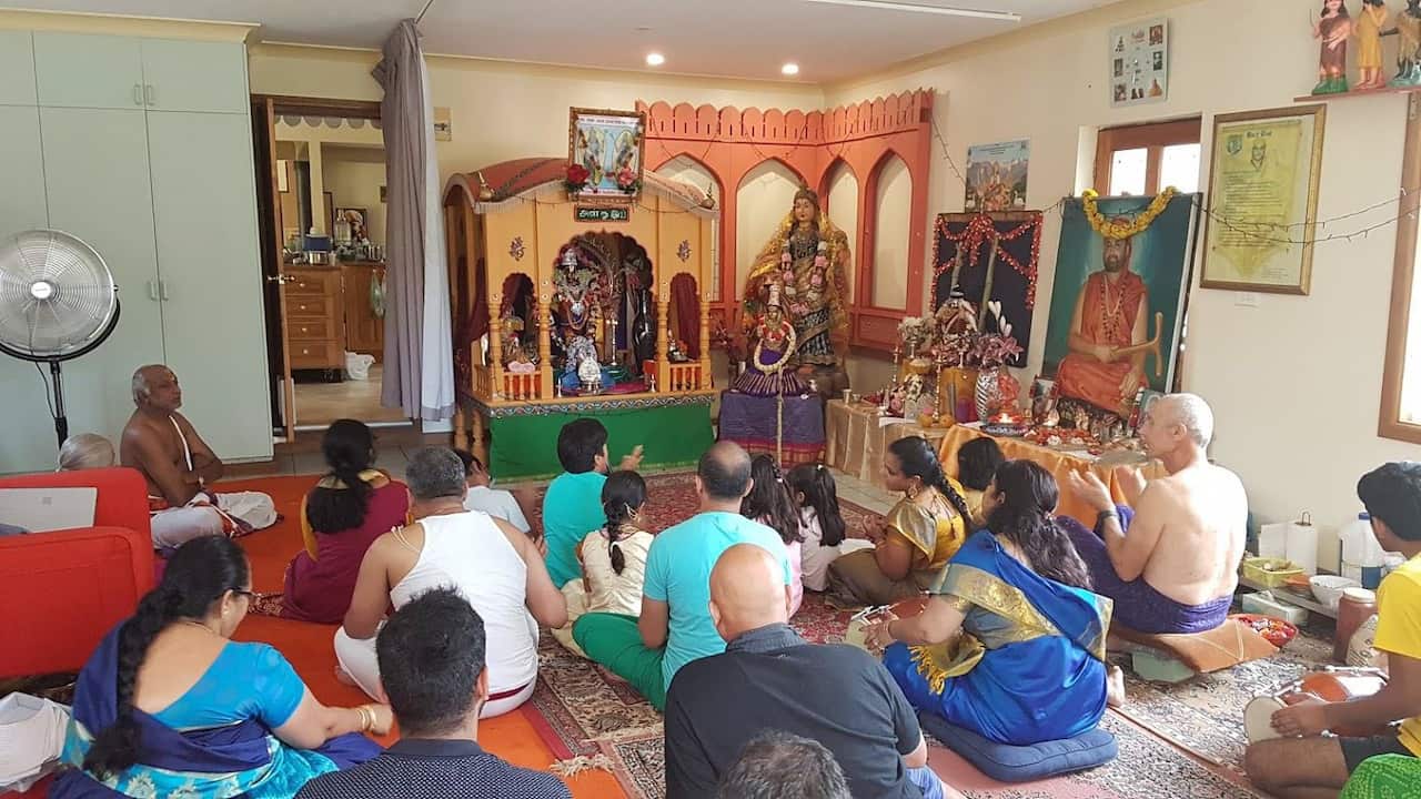 Devotees in Hindu temple which is destroyed in bushfire