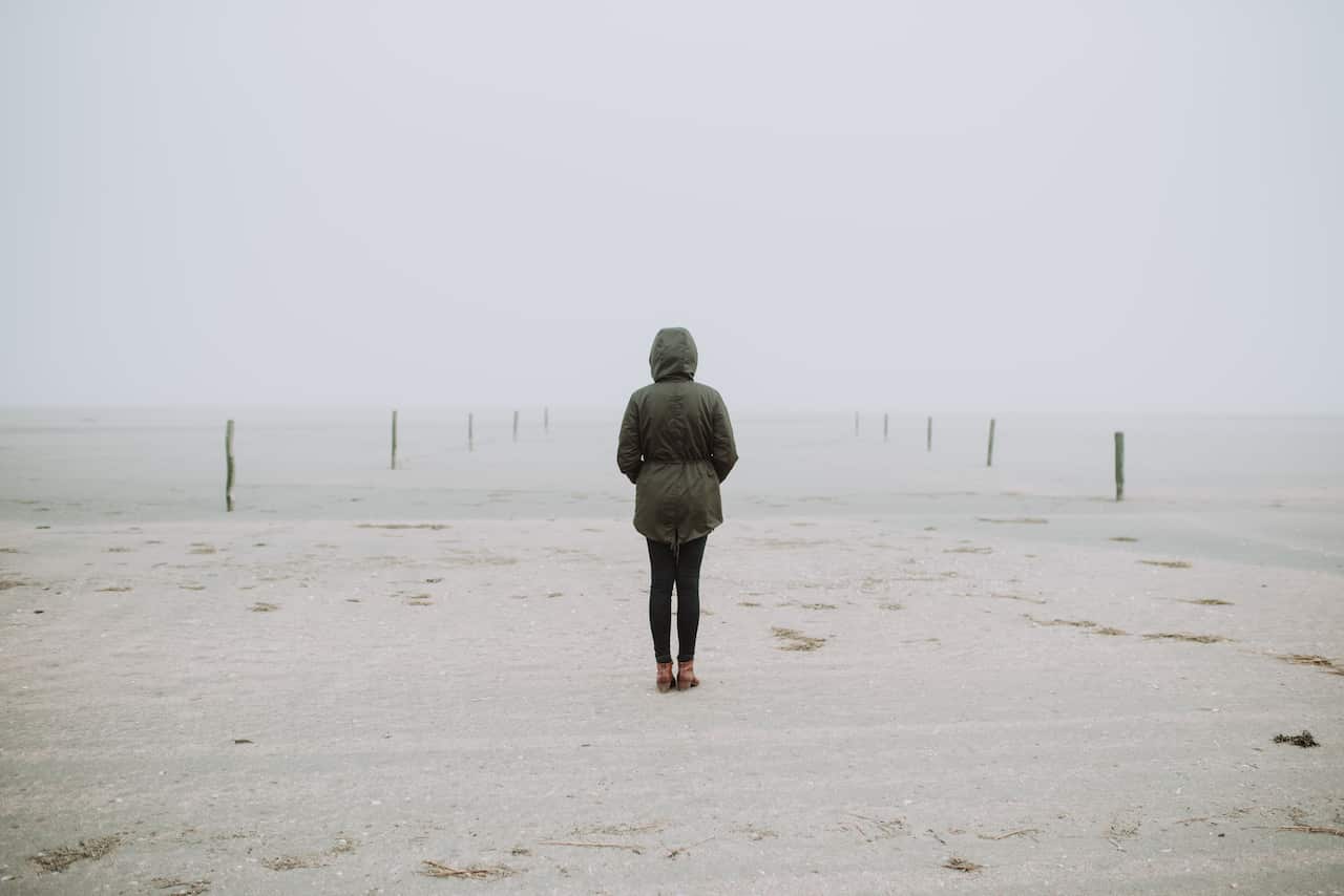 Woman standing on the empty beach