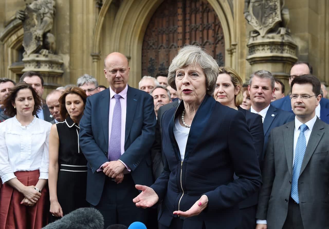 Theresa May delivers a statement outside parliament in London, Britain,
