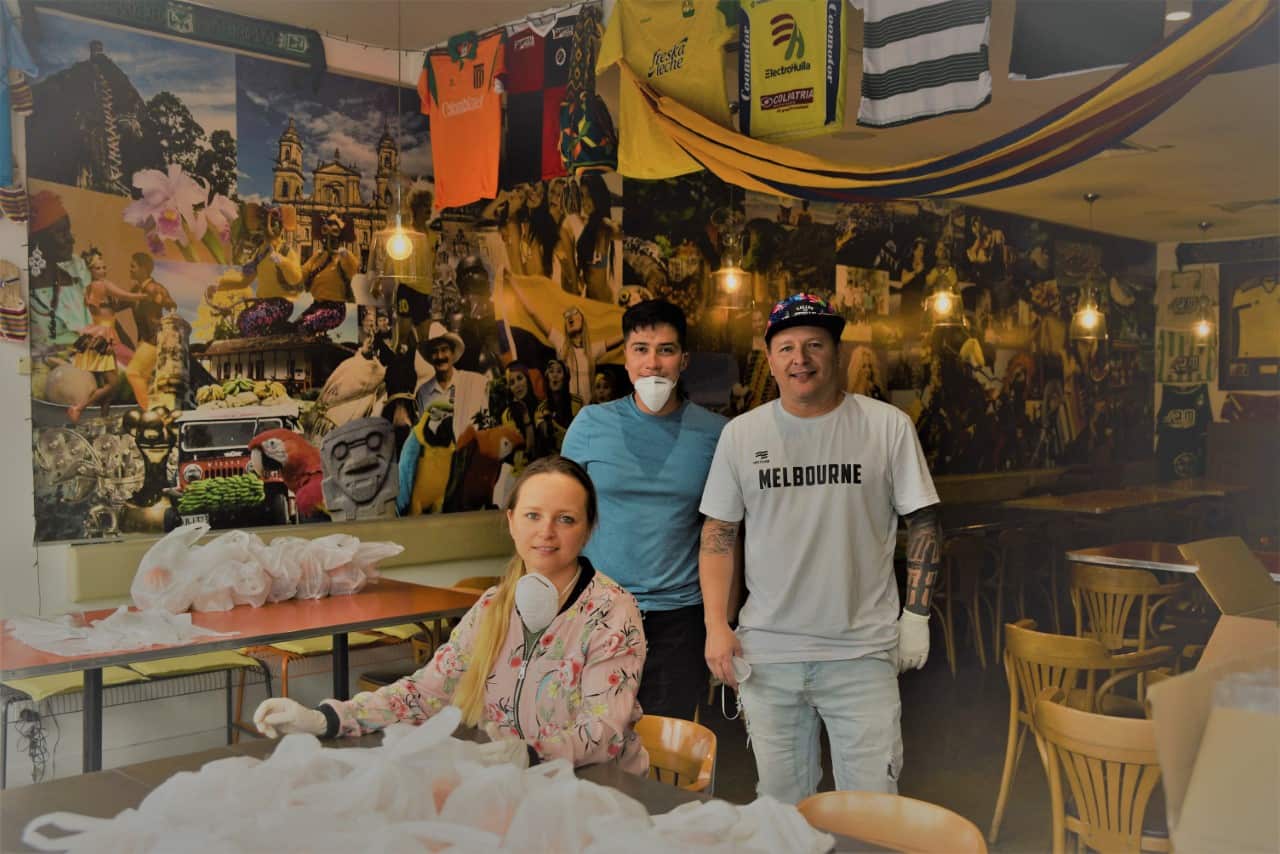 La Tienda Restaurant owner, John Gomez, packing groceries to offer for free to international students in need