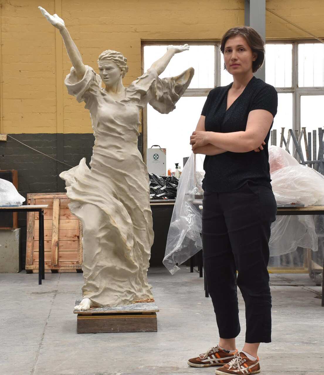 Nina Sanadze in the studio with her clay sculpture model Call to Peace. Photo by Mark Henry, February 2022