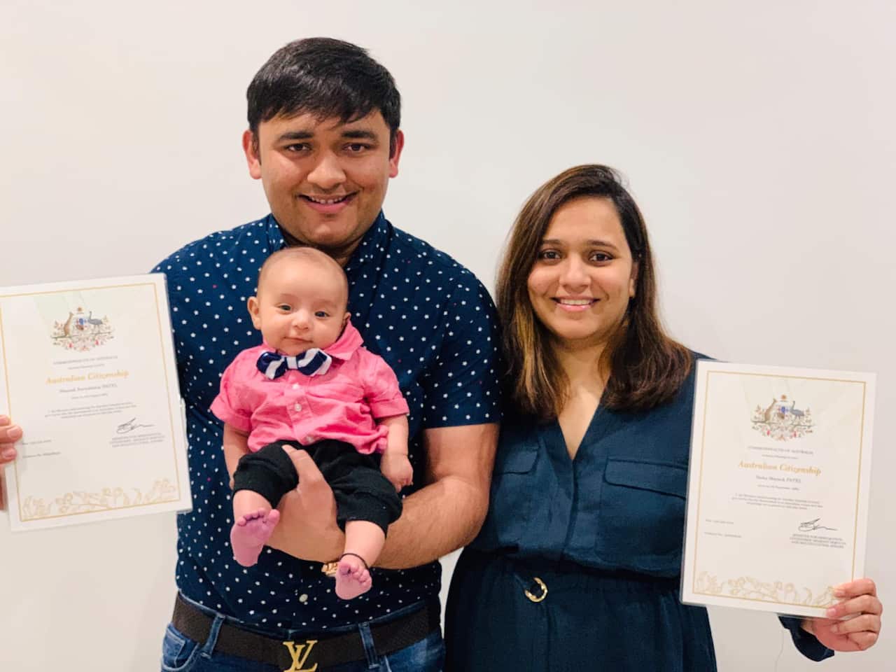 Mayank and Yesha with thier son, Mishaay and Australian citizenship certificate.