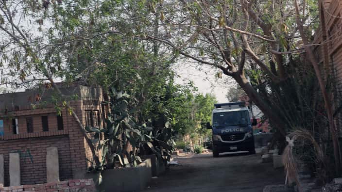 Egyptian security officials in a vehicle guard the cemetary were former Egyptian President Mohamed Morsi was buried in Cairo