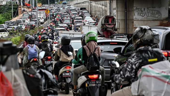 Motorists sit in a heavy traffic during the afternoon rush hour in Jakarta on February 21, 2019.