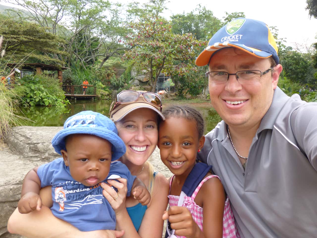 photograph of Tsehay Hawkins' intercultural adoptive family in front of pond