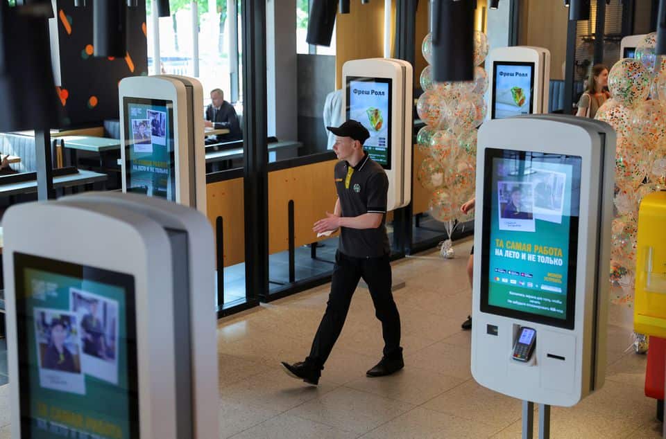 An employee takes part in preparations before the opening of a new restaurant, following McDonald's Corp company's decision to sell its restaurants in Russia