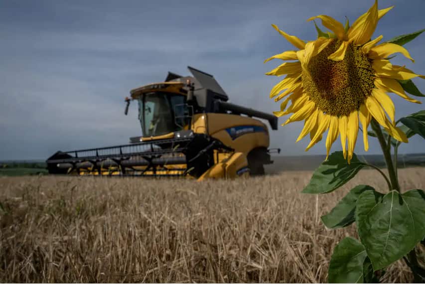 An agricultural implement harvests in a wheat field outside of the city centre, as the Russia-Ukraine war continues in Zolochiv, Lviv Oblast, Ukraine on 1 August, 2022