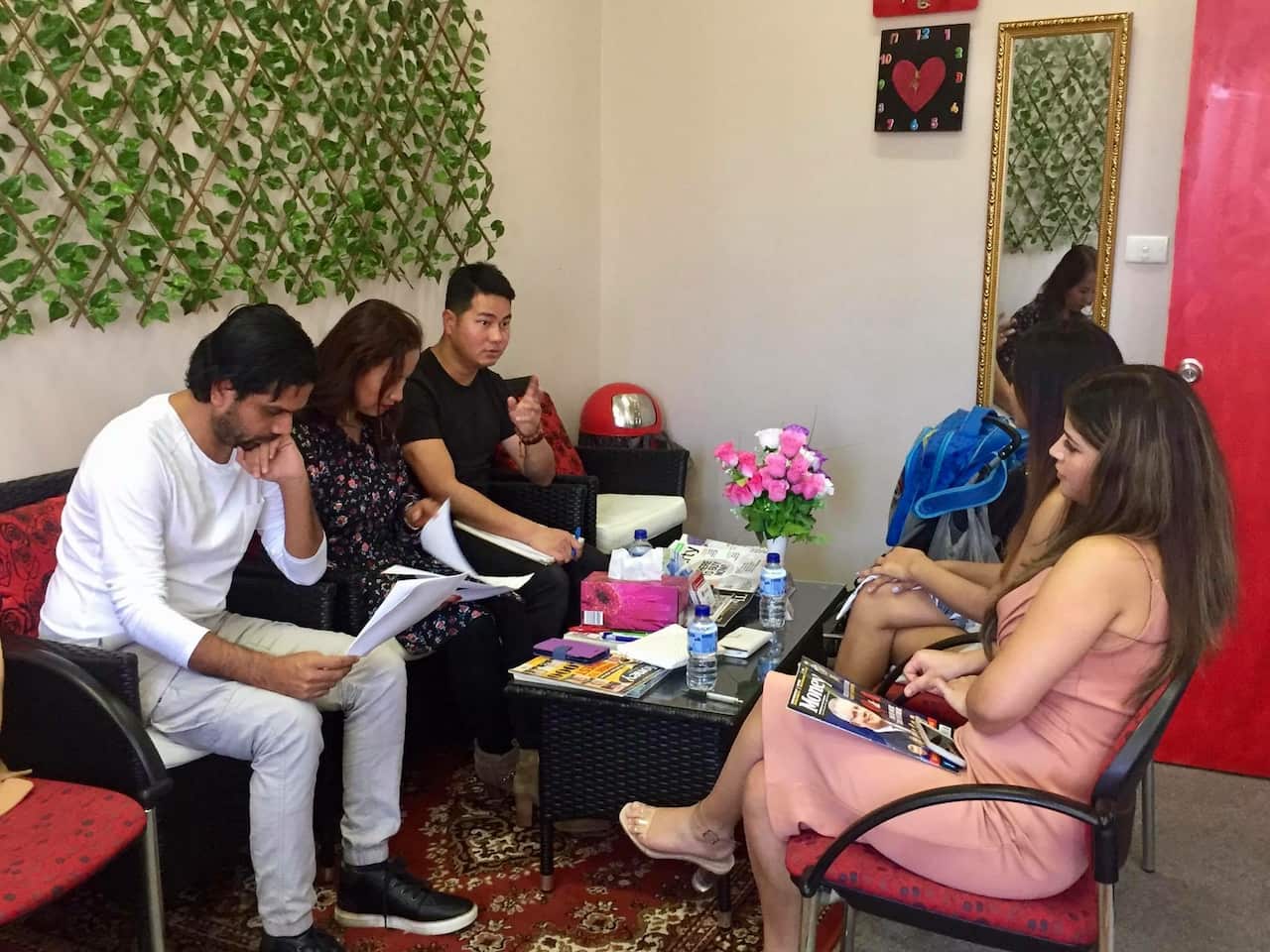 Organizing team from UNAE discussing contestant applications in Sydney.