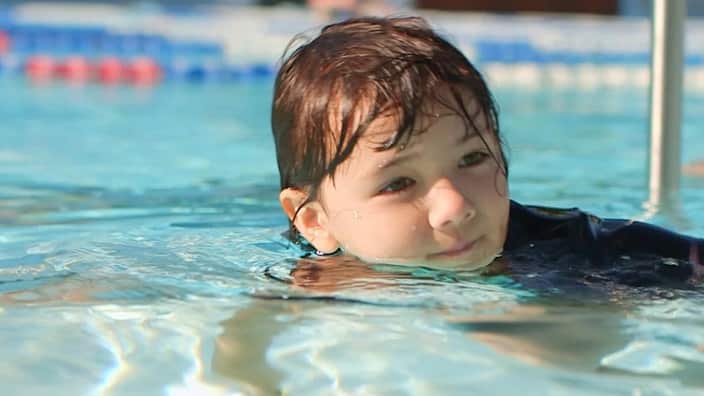 A child in a pool. 