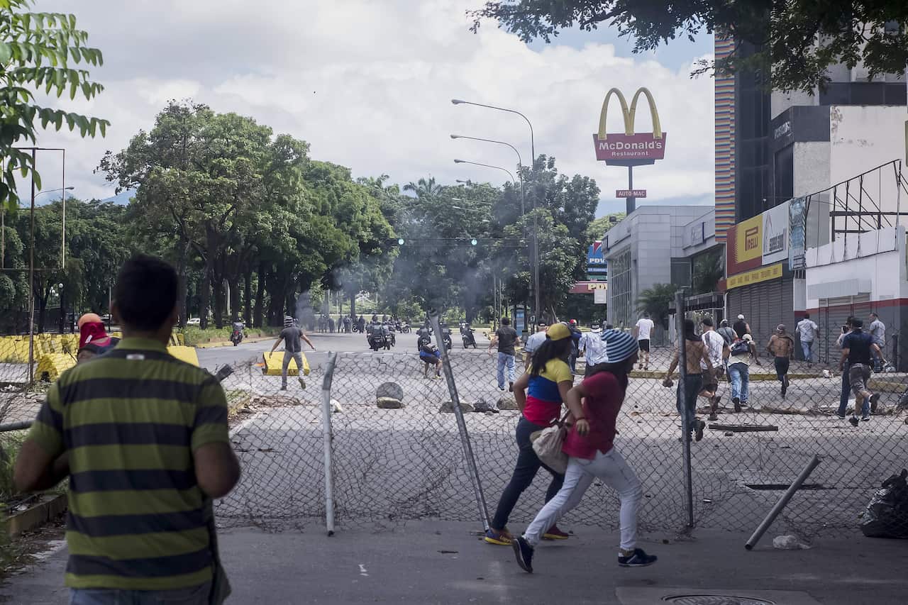 Venezuelan citizens demonstrate in support of a group of military