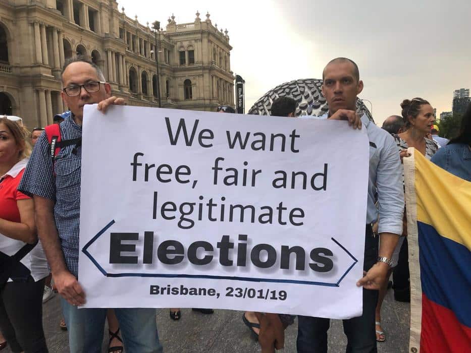 Protesters holding a sign during demonstrations in Brisbane.