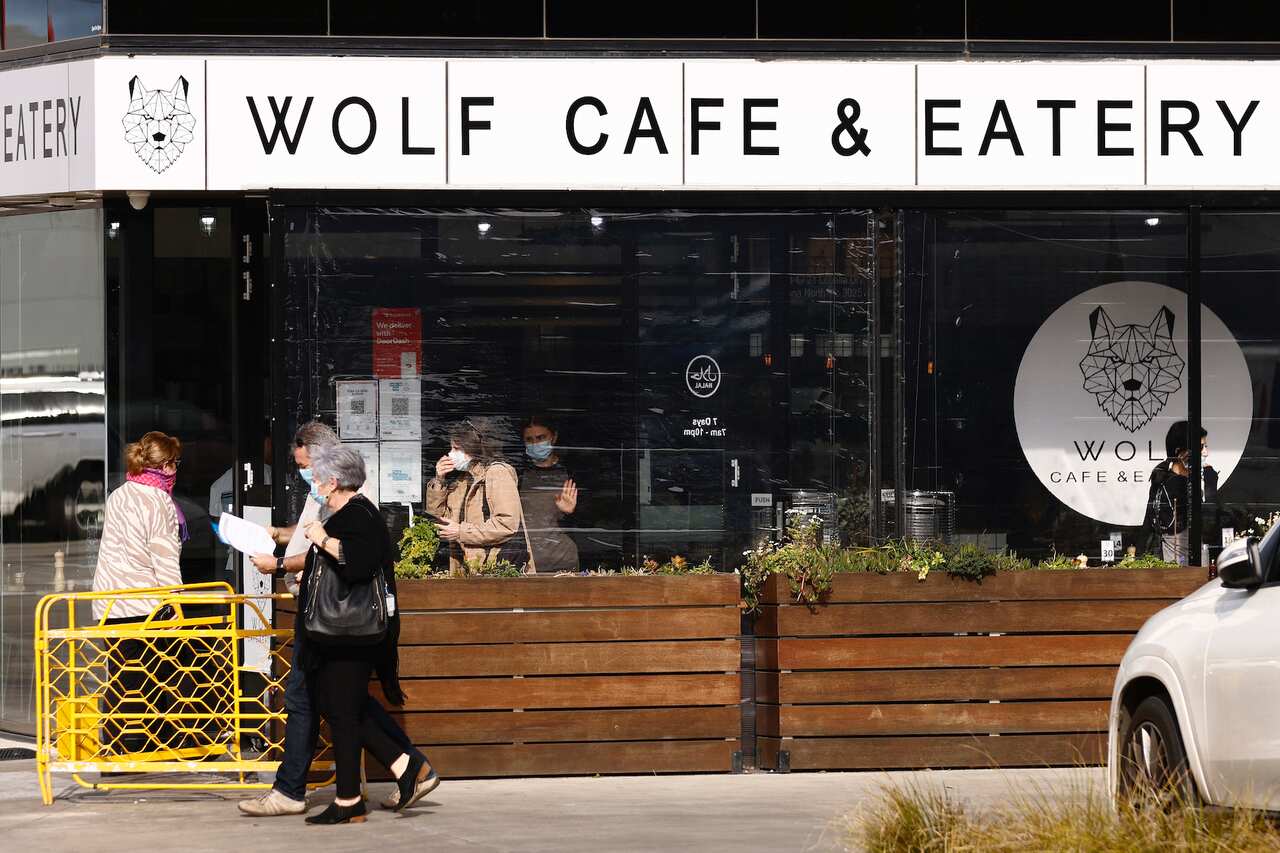 People are seen dining at the Wolf Cafe & Eatery in Altona North after it was announced as a tier 1 site by the government, in Melbourne, Thursday, August 5, 2021. 