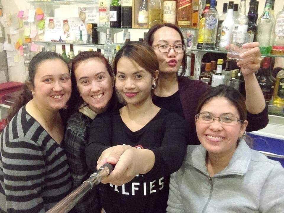 Blessa taking a pose with her co-league in a restaurant