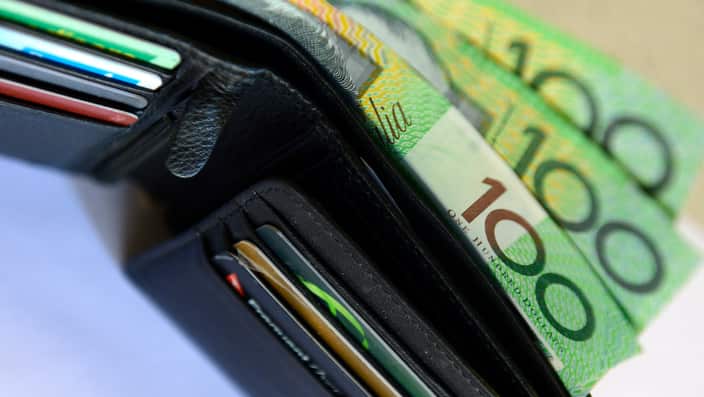 $100 Australian dollar notes pop out of a wallet with credit cards, pictured in Brisbane, Tuesday, Aug. 20, 2013. (AAP Image/Dan Peled) NO ARCHIVING