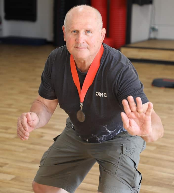 Wally Koenig shows his wrestling stance; He won the silver medal at 1974 Commonwealth Games.