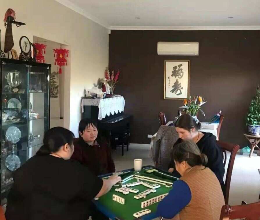 Grandma Wang (on the right) playing mahjong with her family and friends