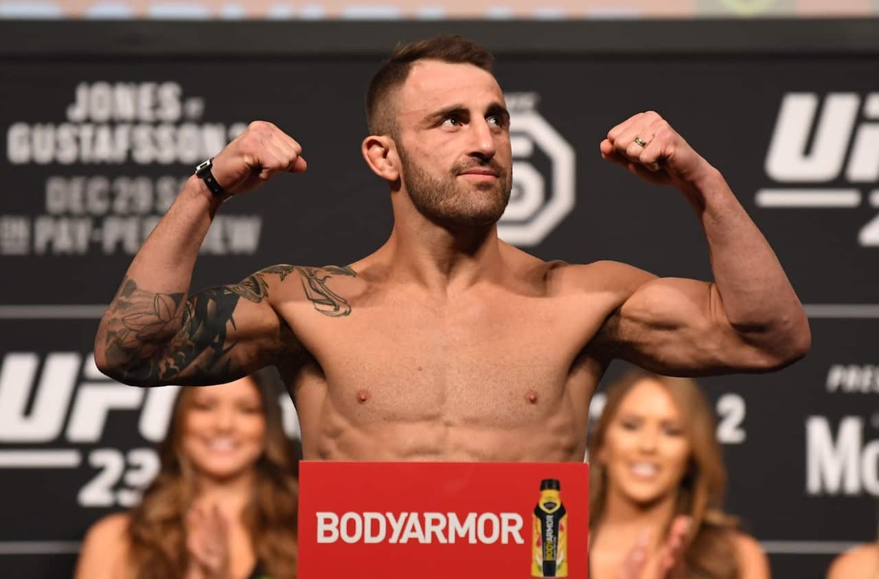 Alexander Volkanovski of Australia poses on the scale during the UFC 232 weigh-in inside The Forum on December 28, 2018