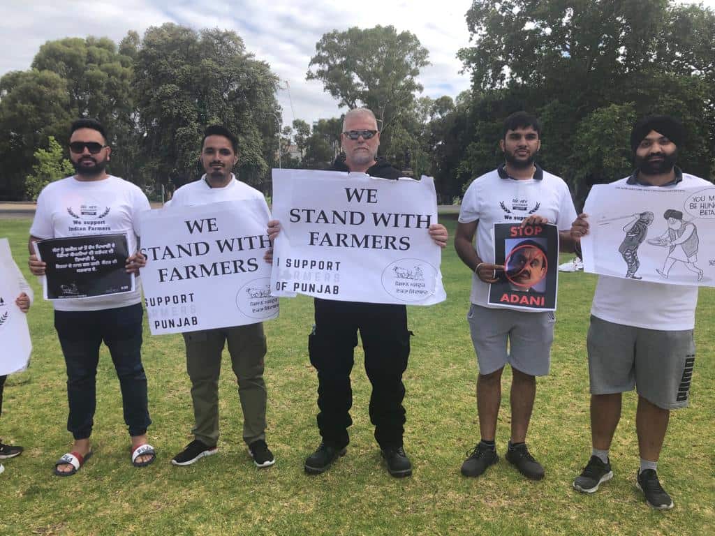 A group of protesters showing banners outside the Adelaide Oval.