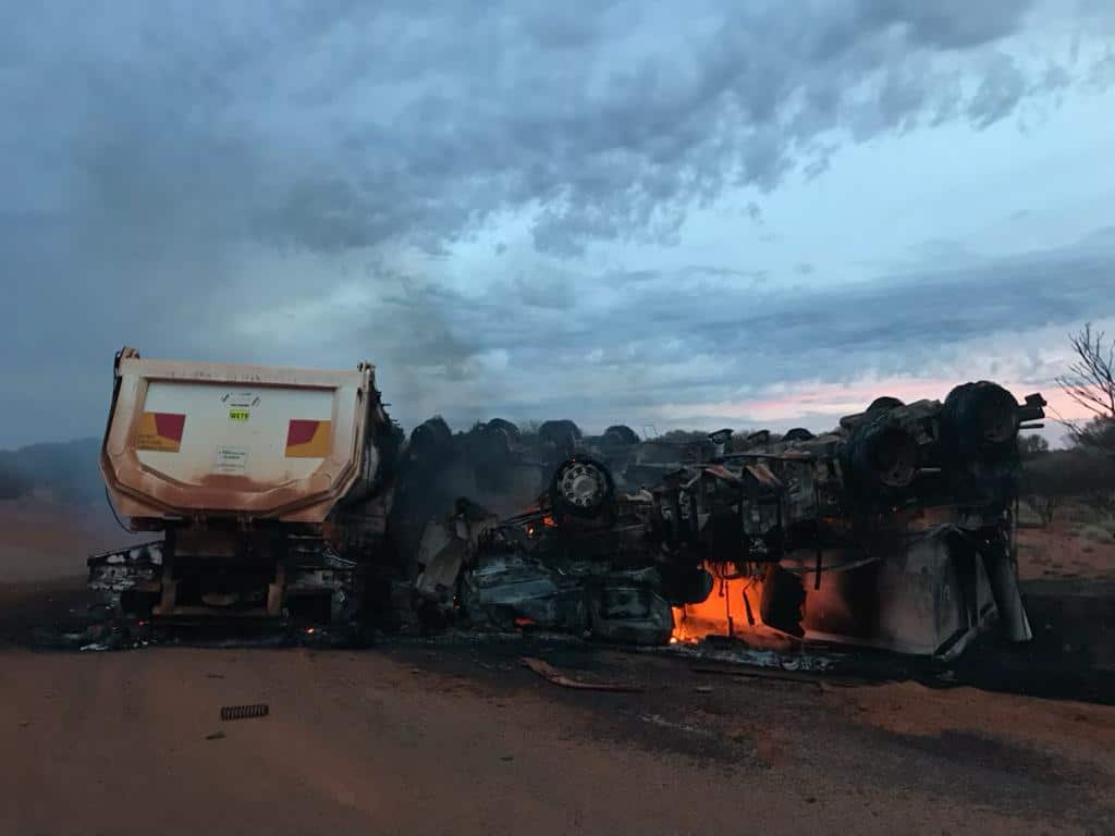 The road train caught fire after the crash on the stretch of a road between Meekatharra and Wiluna in WA.