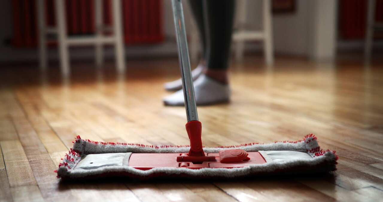 Woman using mop cleaner to do household chores faster