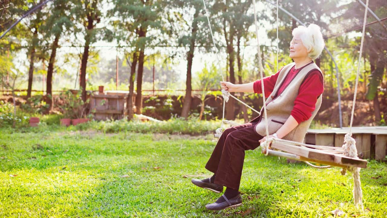 Woman on swing in garden 