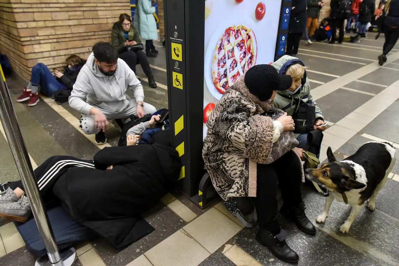 Ukrainians take shelter in a metro station after air raid sirens alarm in Kyiv