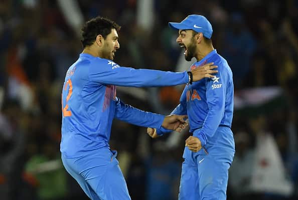 India's Vuvraj Singh(L)celebrates with teammate Vurat Kohli after his dismissal of Australia's Steve Smith during the World T20 cricket tournament match between India and Australia at The Punjab Cricket Stadium Association Stadium in Mohali on March 27, 2