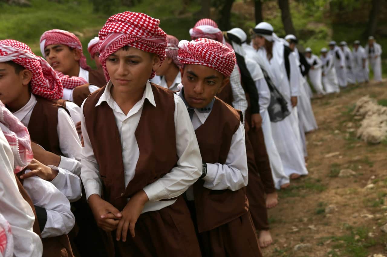 File: Yazidi girls and boys in their traditional clothing 