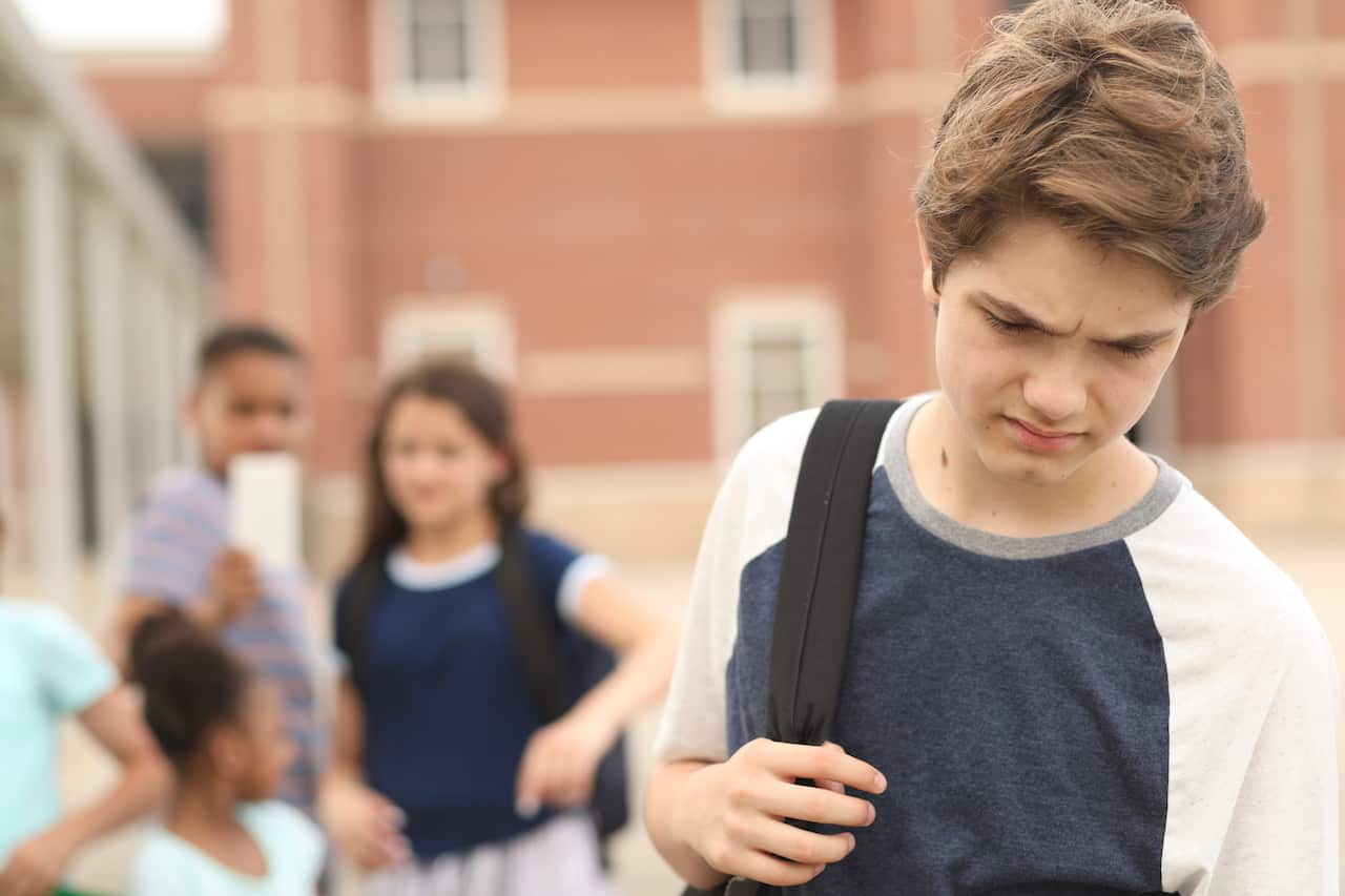 Junior high age boy being bullied at school.