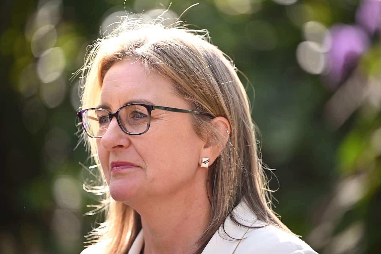 A side profile of a woman wearing glasses.