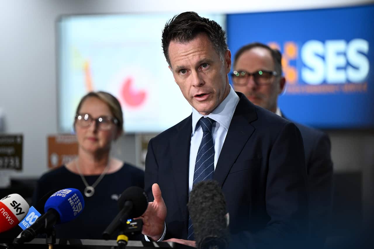 A man in a suit speaking to media