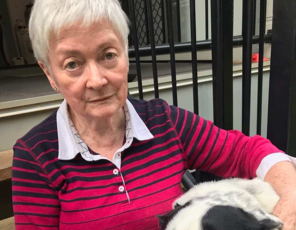 A woman stares into the camera