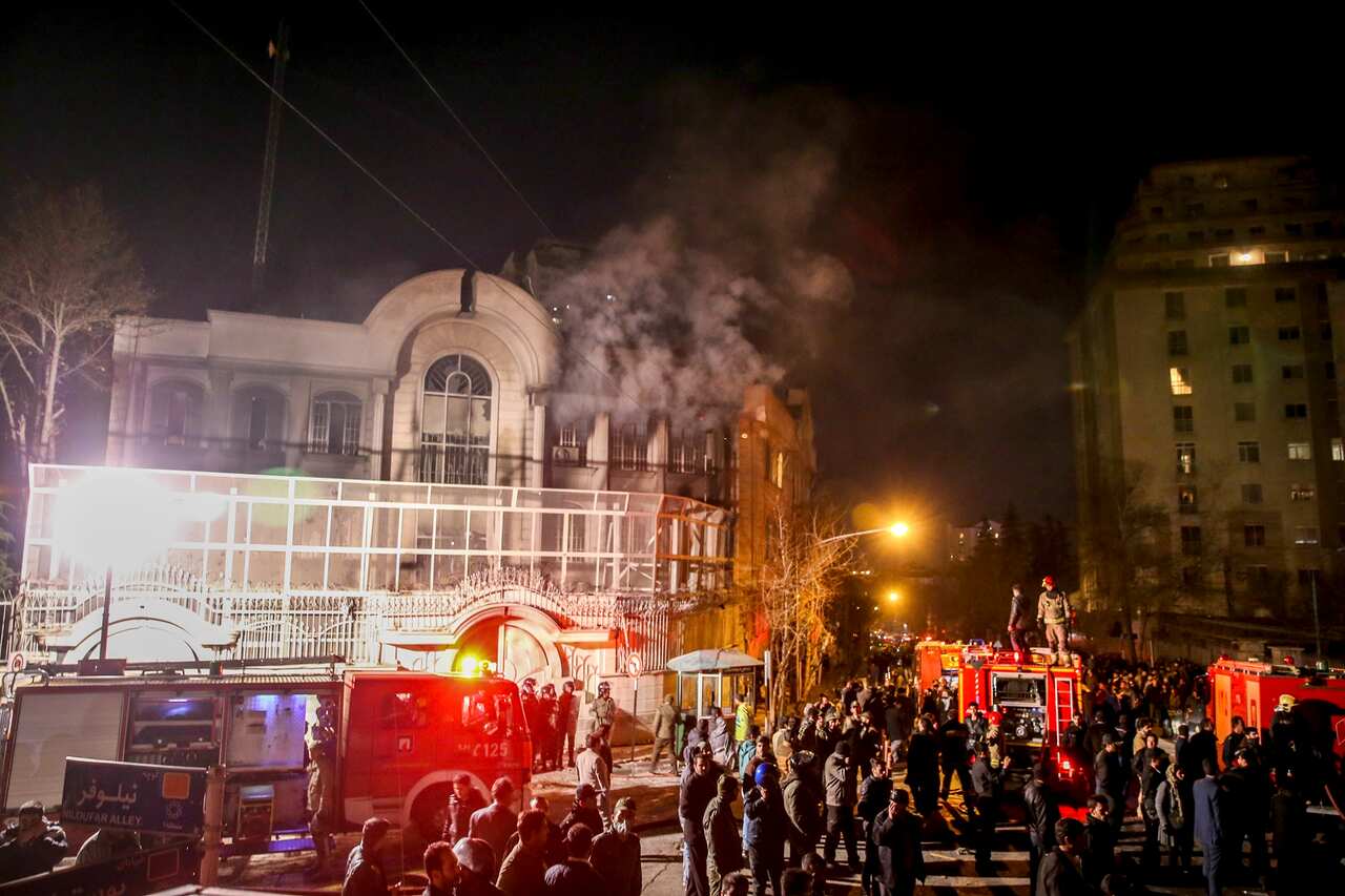 Smoke rises as Iranian protesters set fire to the Saudi embassy in Tehran on 3 January 2016.