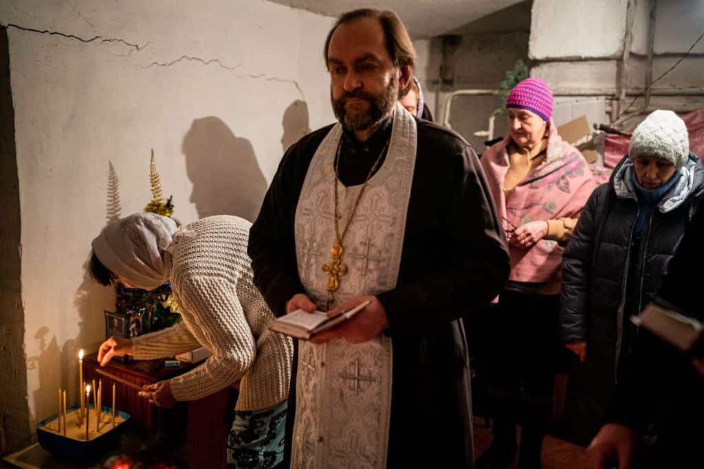 A priest leads an Orthodox Christmas mass in a basement shelter in Chasiv Yar, Eastern Ukraine.