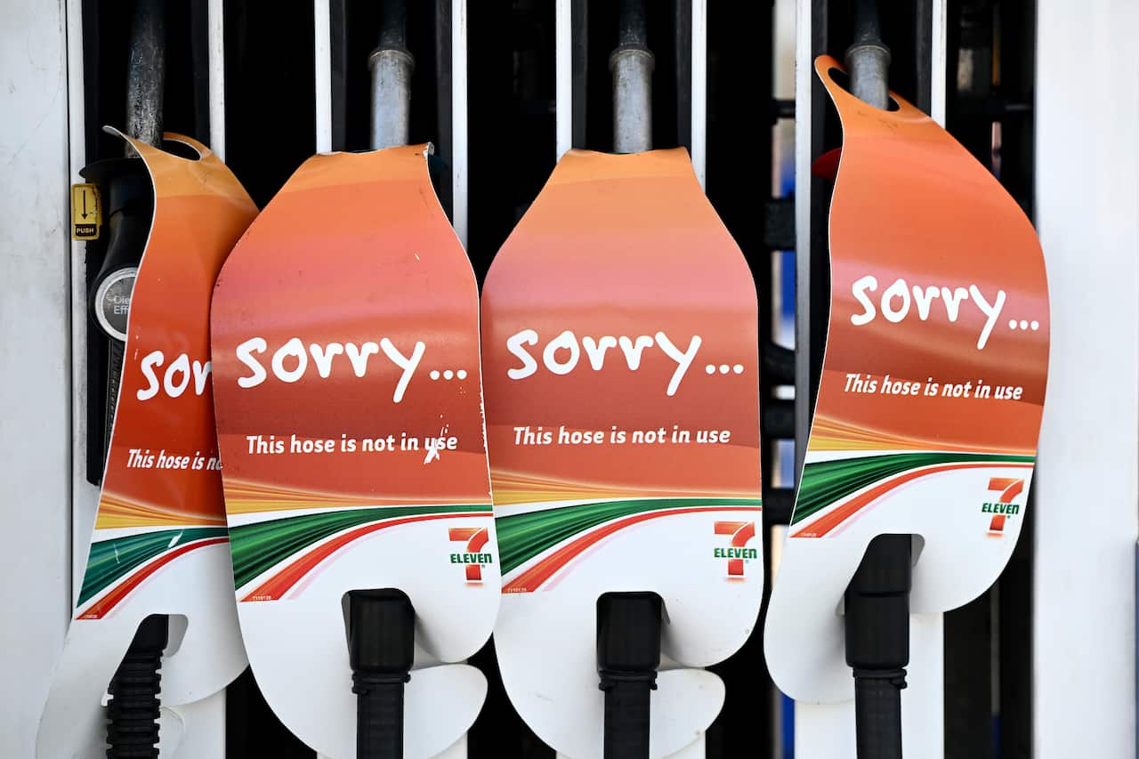 Petrol pumps with signs saying 'sorry this hose is not in use'