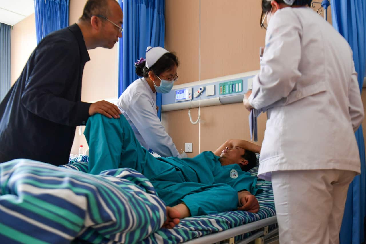 Medical staff attend to an injured person